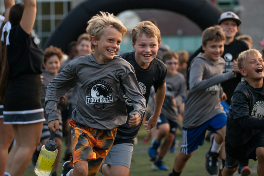 Kids of the Strath Haven Youth Football program run through the tunnel on King Field. On September 16, members of the program were invited to experience a few of the fun things that come with being on the football team.