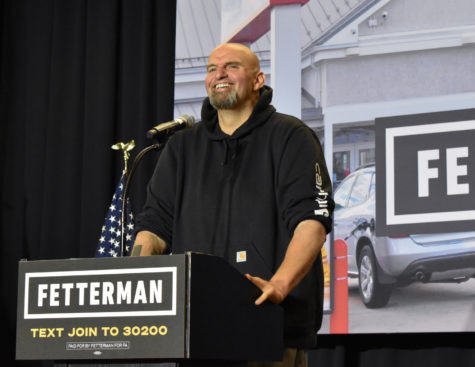 Fetterman smiles over the crowd in NPE gym at October rally.