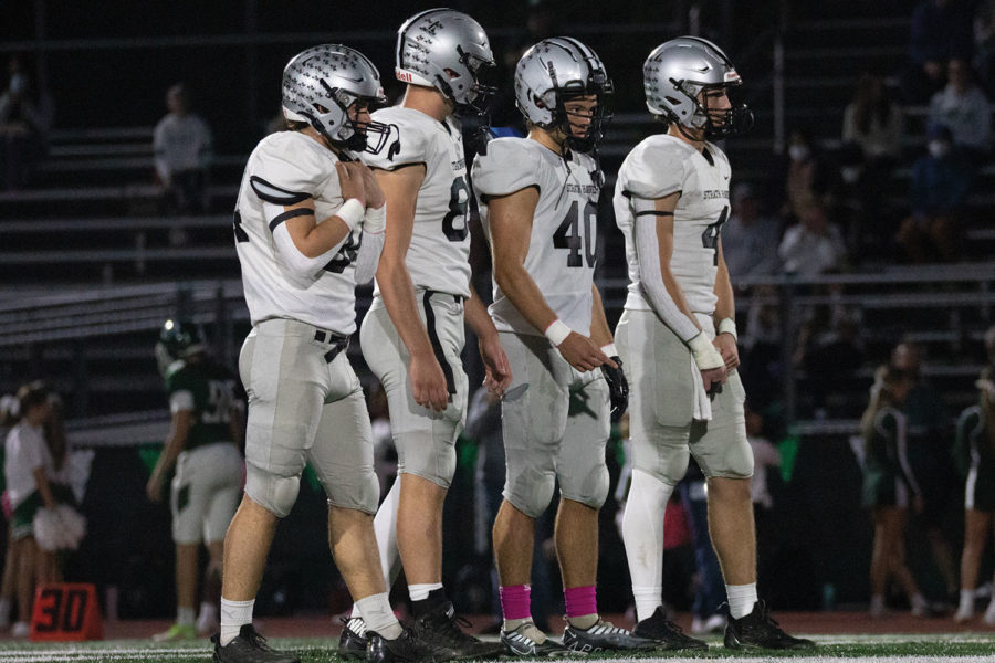 Senior football captains Anthony Crawford, Ben Farabaugh, Bobby Fooskas and Sam Milligan prepare for the coin toss at the Oct. 7 away game versus Ridley. Haven won 41-16.