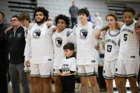 Varsity basketball players line up for the national anthem prior to the home game versus Ridley on Thursday, Jan. 19.