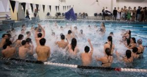 After a fun, hyper chant, the entire swimming team creates splashes in excitement of their final meet against Conestoga and senior night on Feb. 2, 2023.