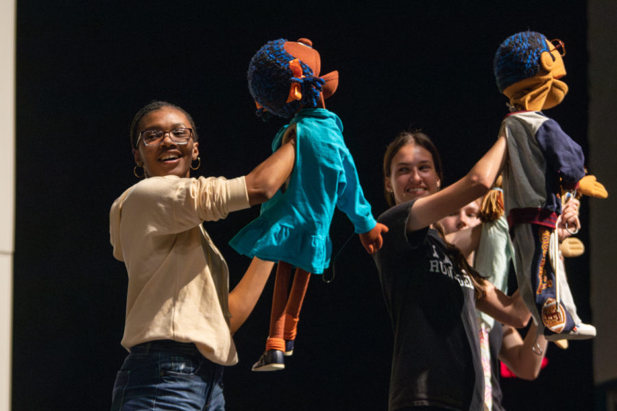 Junior Anyae Poindexter and senior Megan Noon operate puppets during contestant Mackenzie Murrays talent performance.