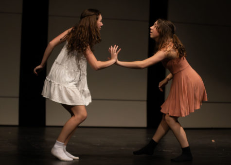 Juniors Lanie and Amy Clark reach for each other’s hands during their duet at the Dance Haven show on May 19.