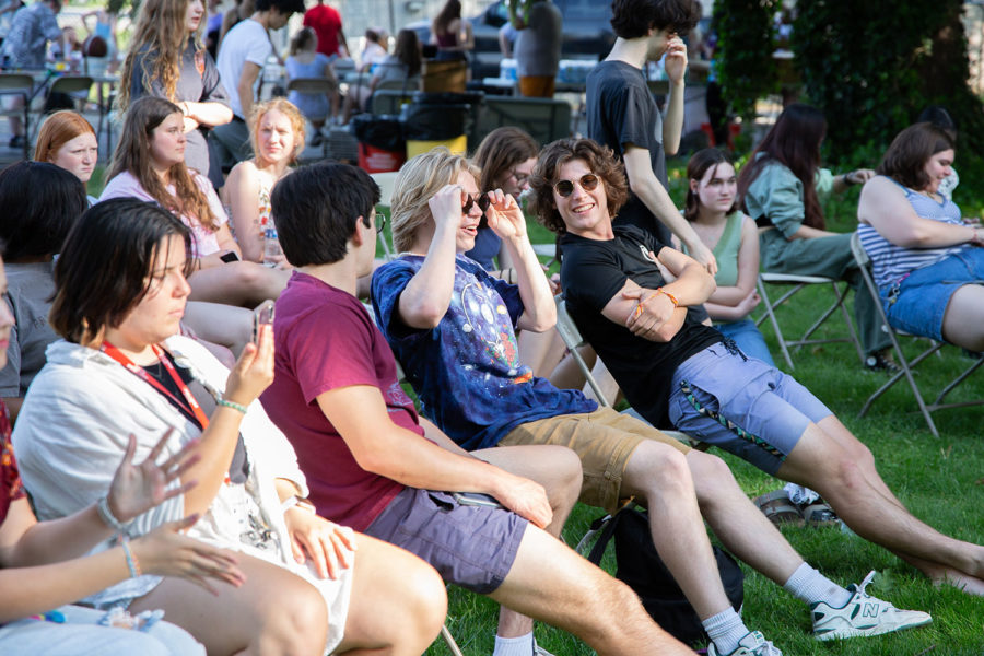 Students relax while watching live performances at the spring fling.