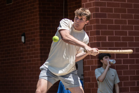 Senior Harry Midgette swings his stick to hit the tennis ball during a stickball game at C lunch on June 1st.