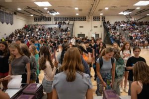 Yearbook staff members distribute the 2023 yearbook at an assembly on August 31.