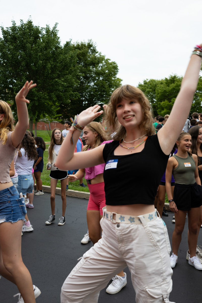 Freshman Leah Reece dances to the music during a game of freeze dance on August 23 at freshmen orientation. 