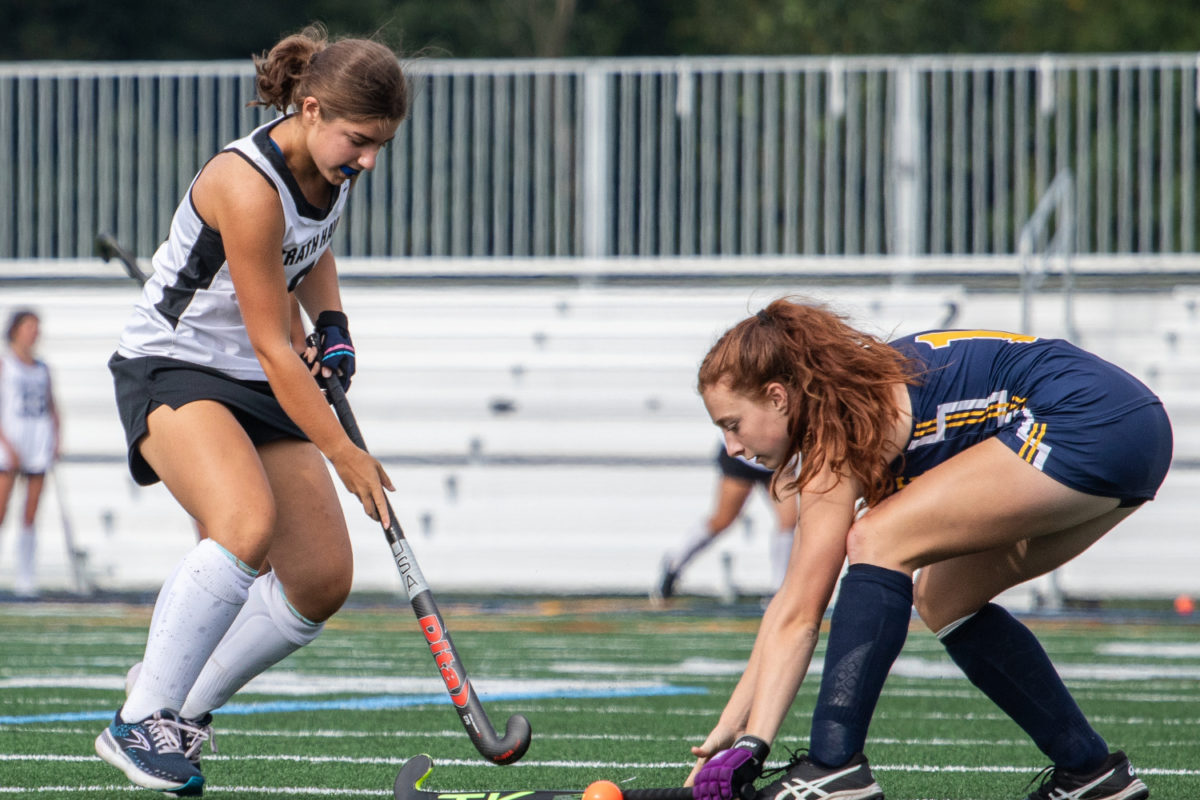 Junior+Cate+Whitehead+takes+on+an+opponent+from+Unionville+at+the+varsity+field+hockey+game+on+August+30%2C+shortly+after+the+first+games+on+the+turf+began+on+August+22.