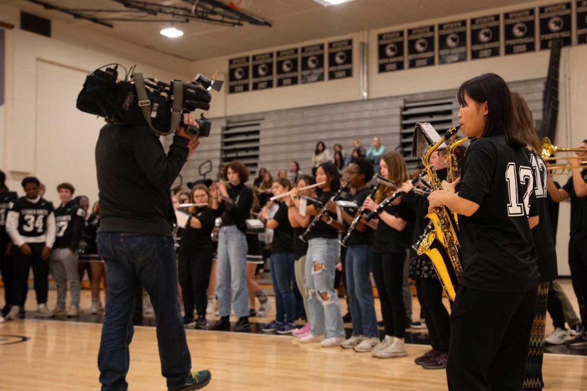LIVE MUSIC • Swaying side to side, the Marching Band leadership team performs “Hip Hop Stadium Blasters” for the camera during the FOX29 live broadcast in the gym on November 30. A part of the news report covered the impact of the marching band on the football team’s performance. “I love the Band being here. They’re the best band in Delco and in the country,” senior Jake Kitchin said. “During timeouts, they get [the team] so hype.”
