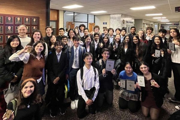 The Speech and Debate team all smile with their awards in hand after the La Salle competition on December 9, 2023. 
