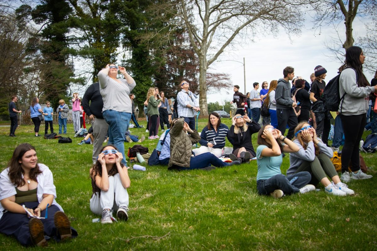Haven students and staff view the solar eclipse through specialized glasses. The eclipse watch party, hosted by admin, began at 2:15 p.m., with peak coverage of the sun at 3:23 p.m. and ran until the eclipse had completed.