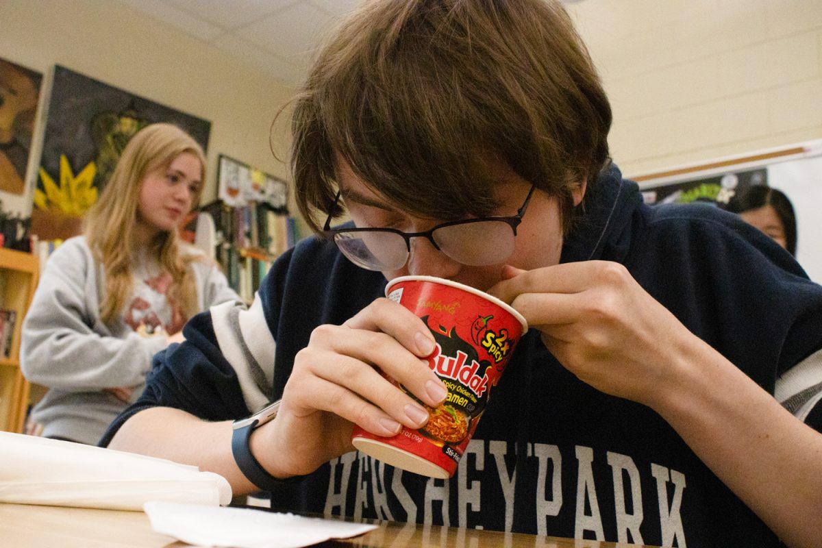 Junior JJ Bohr enjoys fire noodles during the challenge.