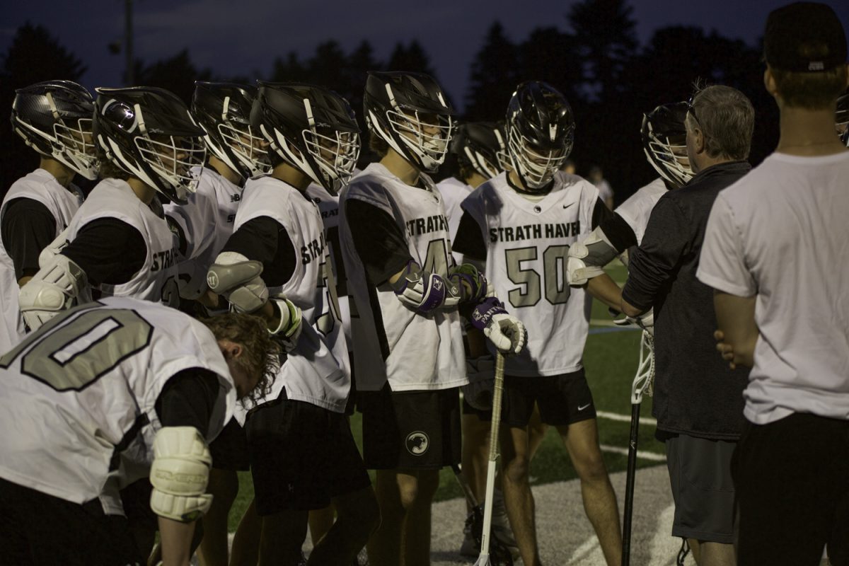 Varsity boys lacrosse huddles during their match against Lower Merion on May 7.