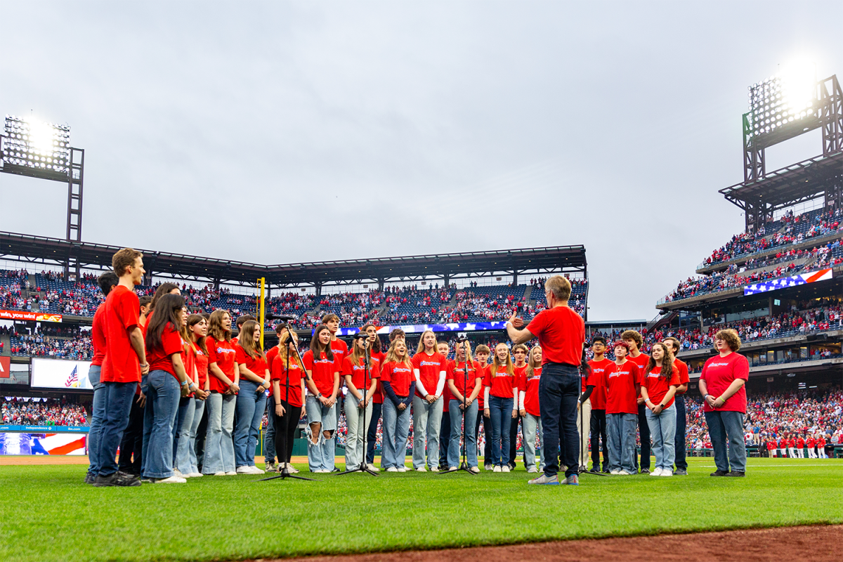 The Strath Haven Silvertones sing The Star-Spangled Banner in choral ensemble position on the field of Citizen Bank Park on Sunday, May 5.
