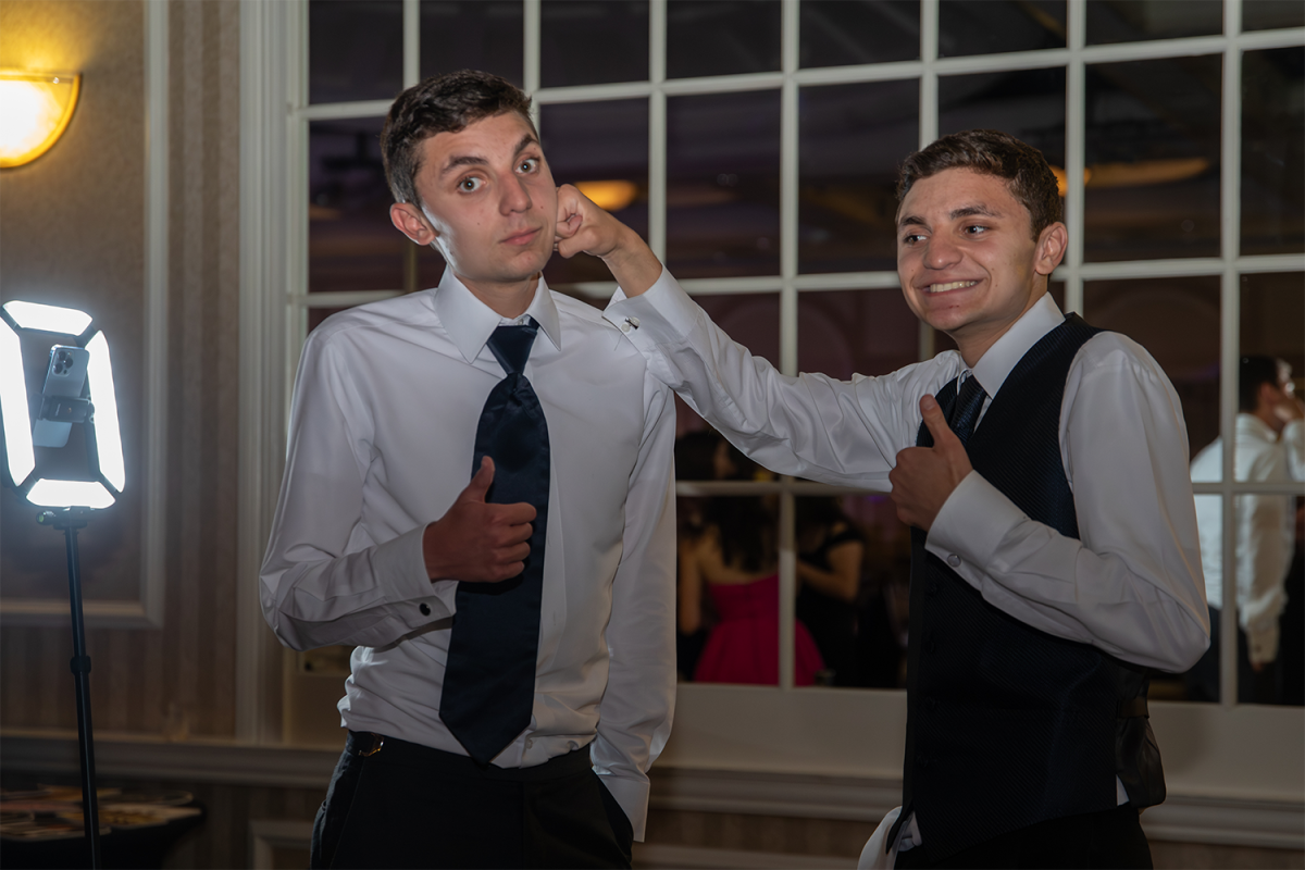 Seniors twin brothers Tommy and Nick Tapino re-create their funny fighting picture from last years junior prom at senior prom on May 17. This year, the twins kept it more light-hearted and enjoyed the funny moment to capture their relationship. We knew we had to do it based on how everyone reacted to last years photo, Tommy Tapino said. 