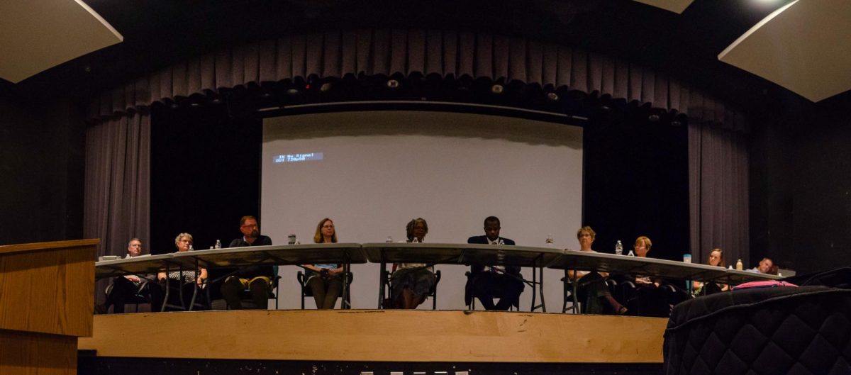 School board members sit at the front of the stage in an array of foldable tables in the Strath Haven Middle School Auditorium for the WSSD special school board meeting on Monday, June 23. The meeting was moved to the auditorium for space after the library reached its max occupancy limit.