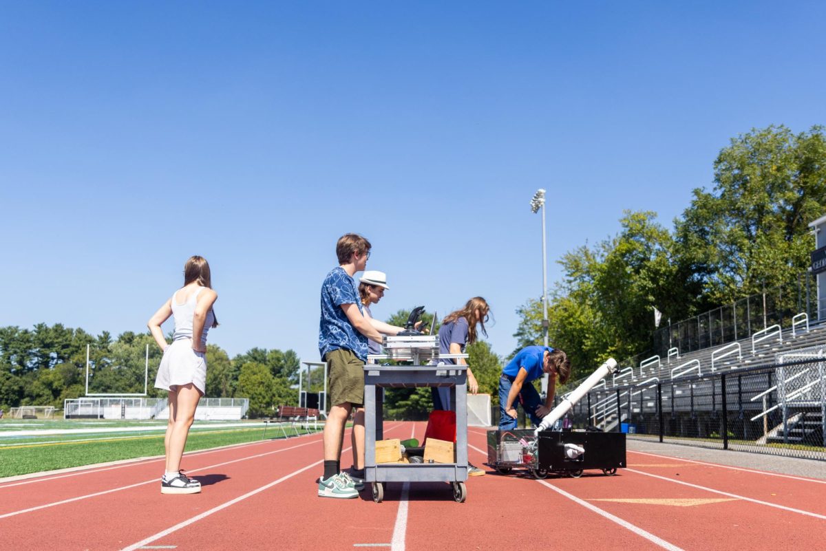 The Positronic Panthers test their ‘Cheer Bot’ at George L. King Field during the 5th block on Wednesday, September 11, before the Varsity football season home opener. The robot will launch mini-footballs and t-shirts into the bleachers in hopes of drawing student interest in the robotics team. 