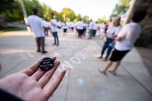 A student holds a "WE SUPPORT WSSD TEACHERS" pin outside of the Strath Haven Middle School prior to the regular school board meeting on Tuesday, August 27. WSEA members distributed pins to community members to show support for WSSD teachers.