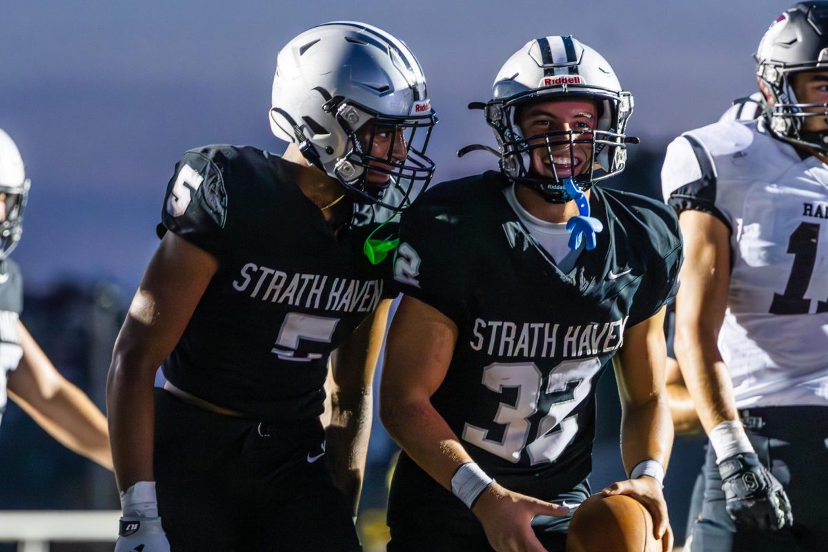 Seniors James Fisher and Shane Green smile and celebrate after scoring a touchdown against the Radnor Raptors during the home season opener on Friday, September 13.