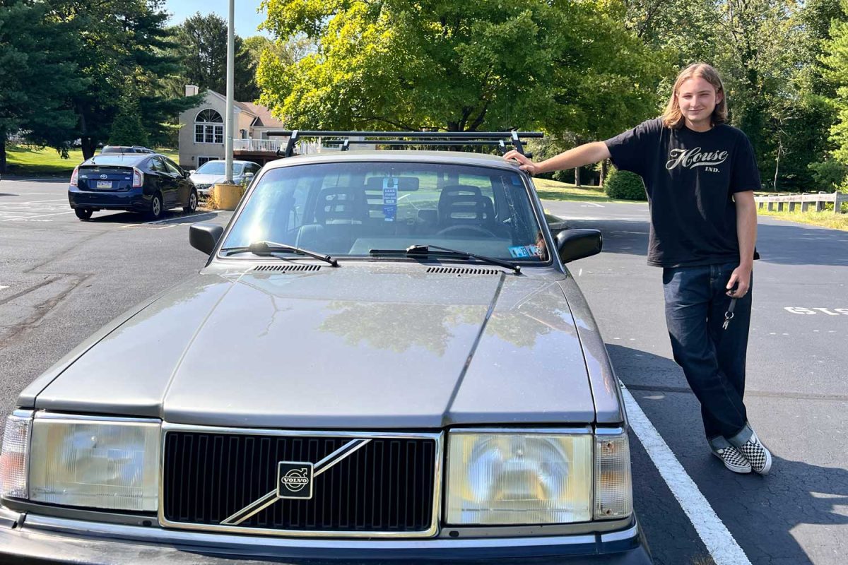 Senior Sam Sentivan poses with his car, a 1993 Volvo 240 Wagon.