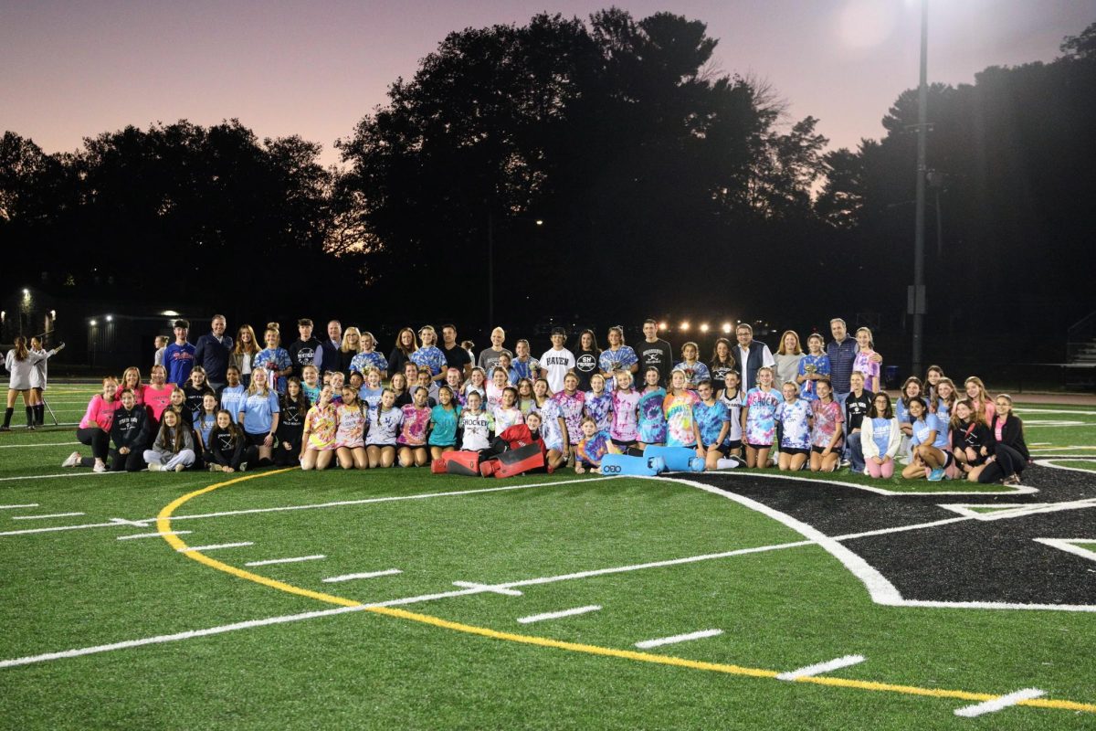 The Strath Haven Women's Field Hockey teams pose for a group photo with their seniors and their parents.