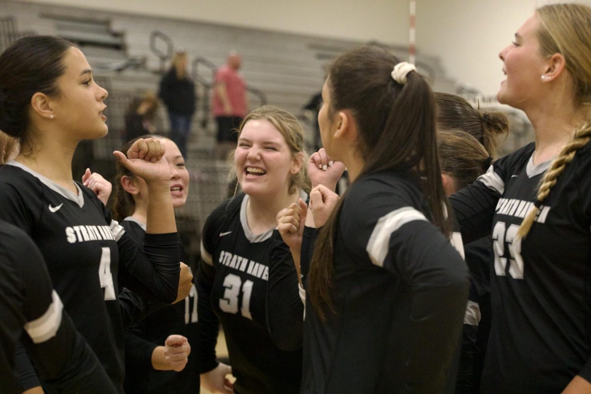 The varsity volleyball team celebrate their playoff win against Chichester with smiles and fist bumps on October 22. 