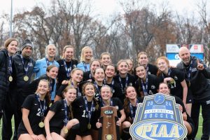 The girls soccer team poses with the PIAA 3A state championship trophy at Eagle View Middle School on November 15. The team defeated Lower Dauphin 1-0 with a goal from sophomore Ava Hurwitz.