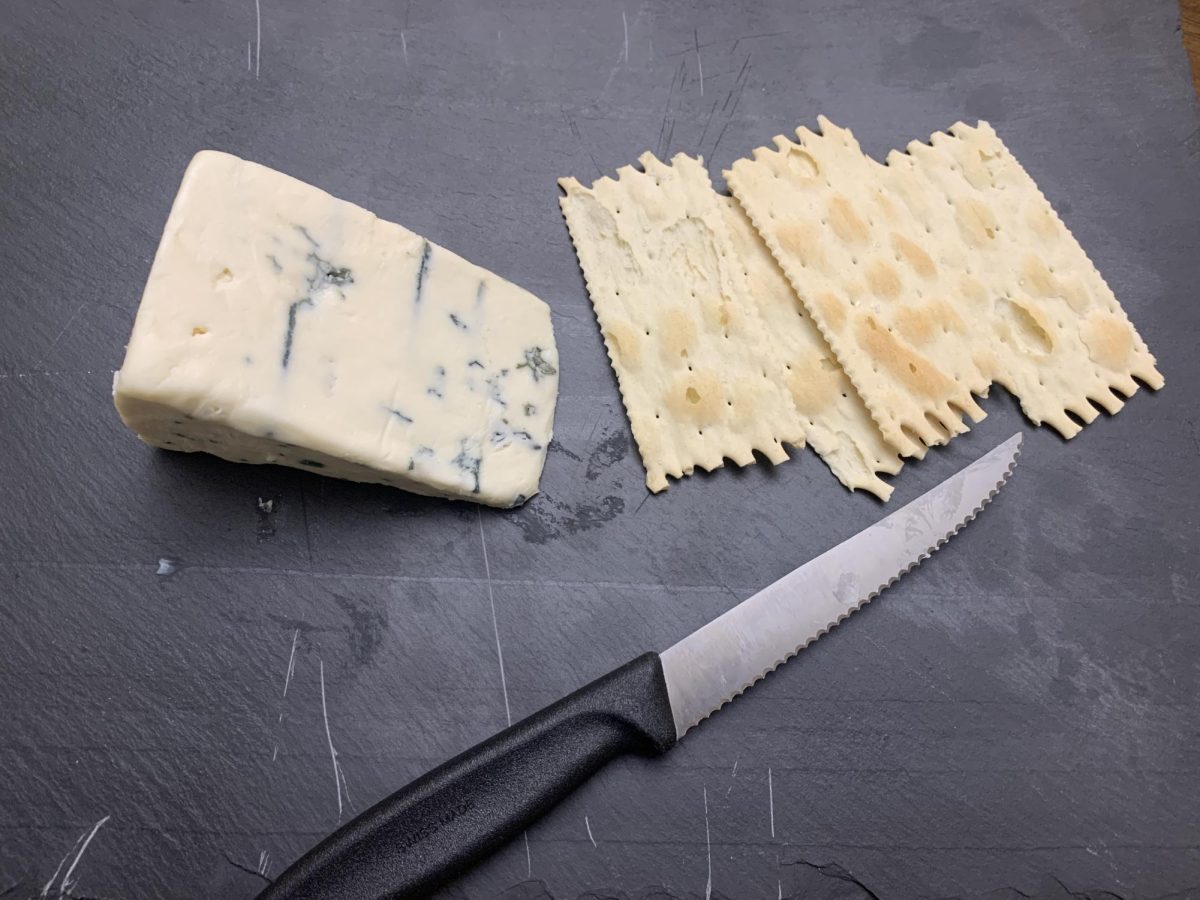 Point Reyes Original Blue being served with crackers.