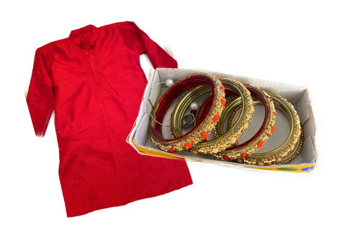 Examples of traditional Indian clothing, the large red shirt is known as a Kurta and the decorated rings are bangles and are meant to worn as bracelets. 