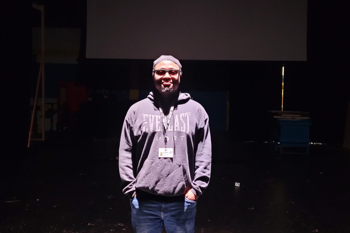 Mr. Jonathan Hardy poses under the spotlight in the auditorium.