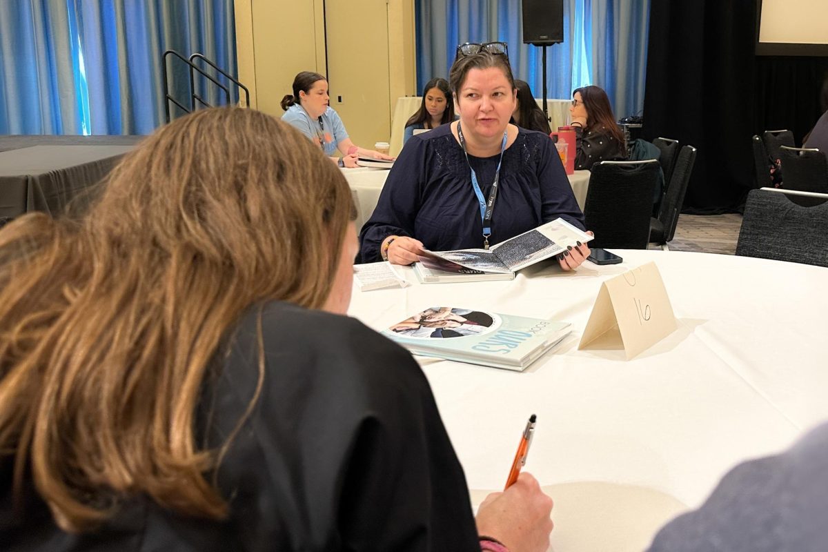 Yearbook staff members take notes as adviser Jen Bladen reviews the 2024 Haven Yearbook.