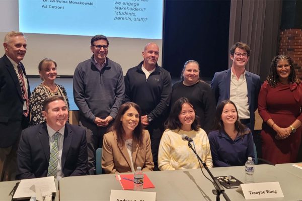 The phone forum panel poses behind the panel’s desk in the Strath Haven Middle school auditorium on October 29.