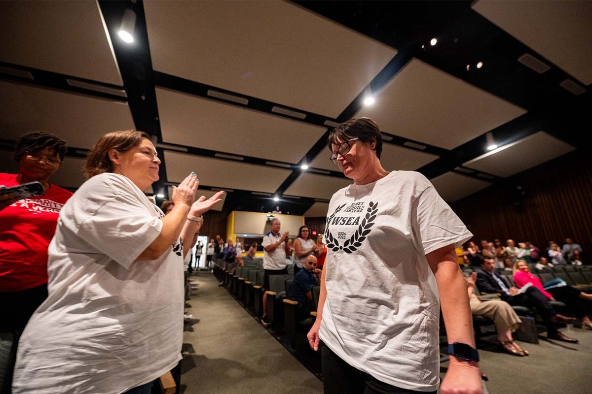 WSSD teachers applaud WSEA President Billie Jo McNamara returns to her seat after being allowed to speak at the public school board meeting, despite not being a resident in the district, on Tuesday, August 27 in the Strath Haven Middle School Auditorium. 