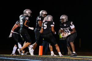 Senior tight end Jahi Curtis (#81, far right) celebrates with the varsity football team after scoring a touchdown in the first quarter of the playoff opener against the Penncrest Lions on Friday, November 1. Following a tackle on Lions quarterback Paul Graham Jr. by junior offensive guard Nick Farabaugh, Curtis recovered the ball and ran it 29 yards into the end zone extending the Panther's lead to 14-0.