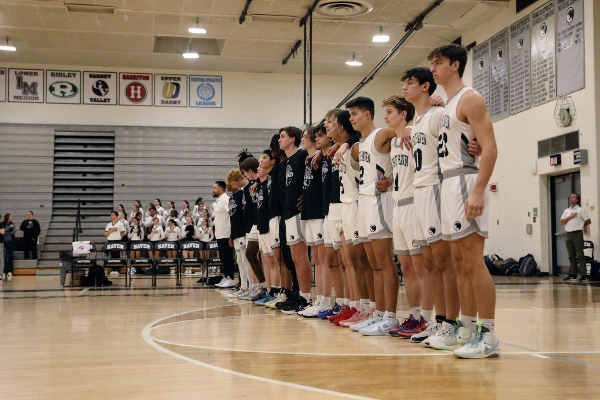 The boys varsity basketball team lines up for the national anthem in the Strath Haven High School gym on December 13.