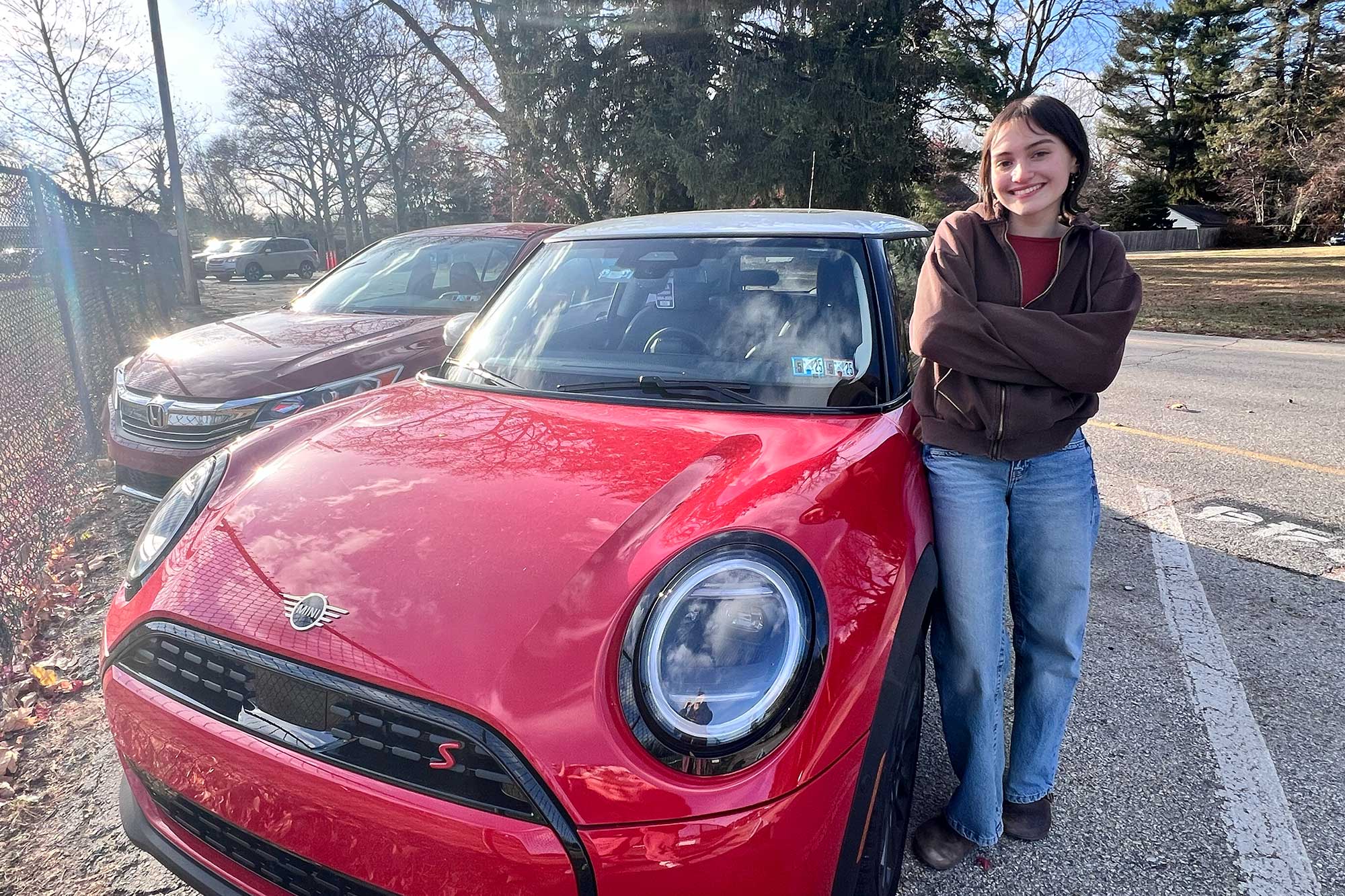 Senior Anya Agha smiles with her red Mini Cooper named Bertha. 