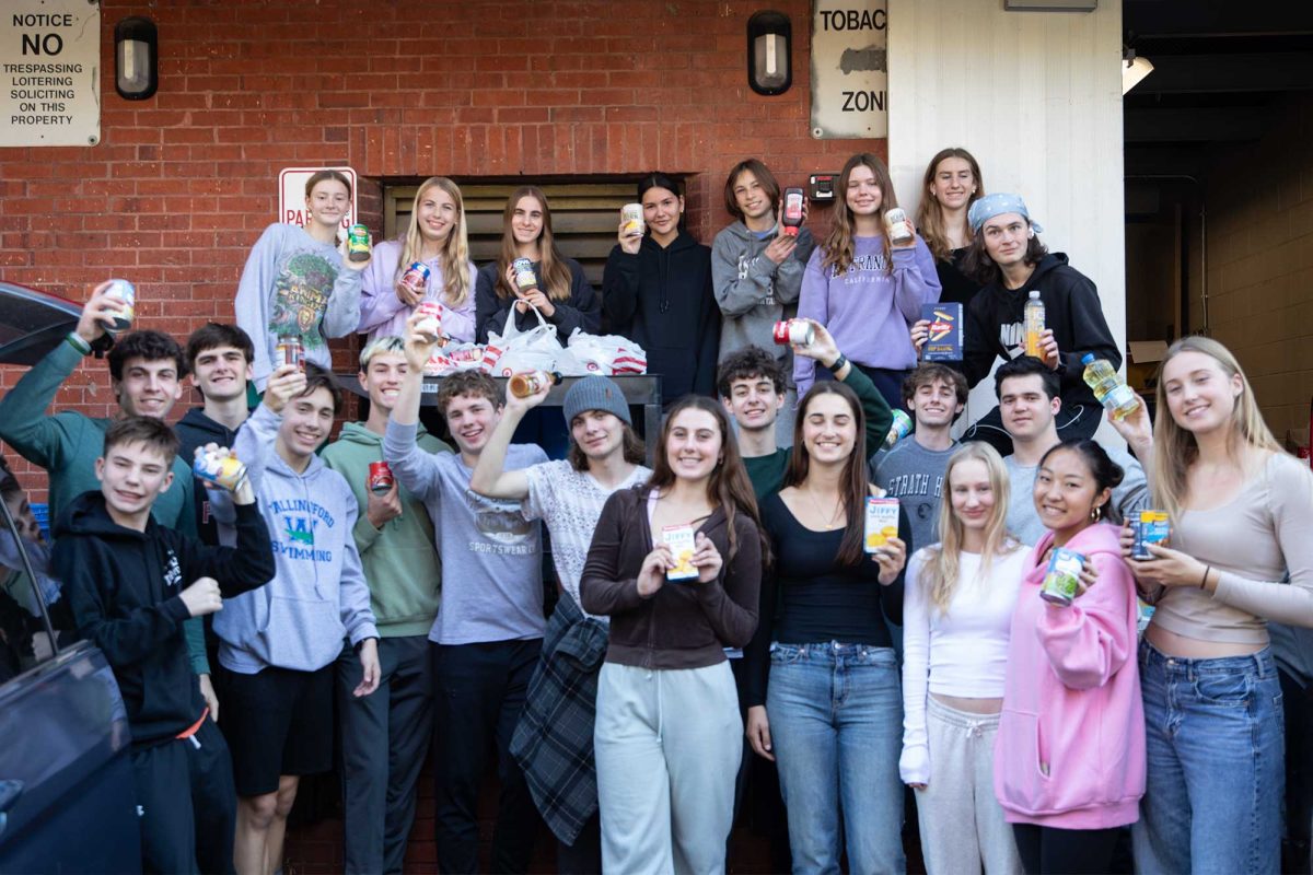 Haven Helps volunteers pose with numerous donations from the canned food drive. The club did hard work loading up all collected items and sending them off to the Media Food Bank.