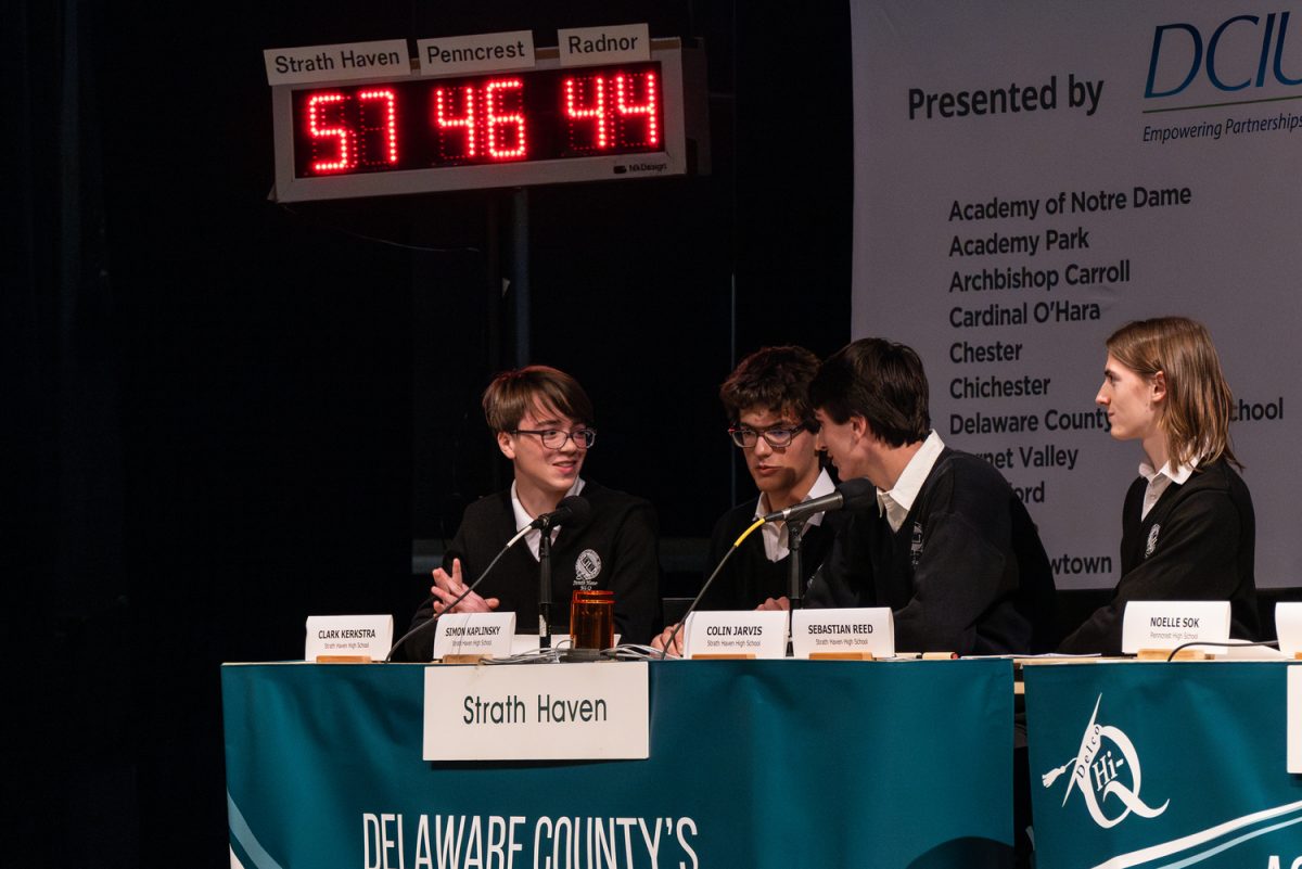 Sophomore Clark Kerkstra, senior Simon Kaplinski, senior Colin Jarvis, and senior Sebastian Reed discuss a final response as the match comes to a close.