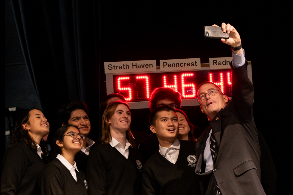 Hi-Q adviser and physics teacher William Rothenbach takes a selfie with the Hi-Q team after their 57 point victory in the first competition of Delco Hi-Q against Radnor and Penncrest on Wednesday, December 4.