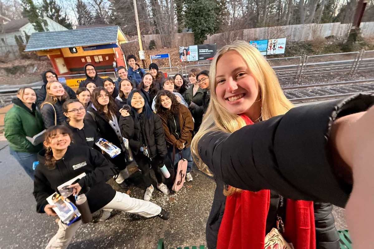 CONVENIENT COMMUTE • Sophomore Kathryn Barrett takes a selfie with members of the yearbook, newspaper, and literary magazine staffs as they prepare to board SEPTA from the Wallingford station for a trip to Temple University on December 6. The one-way cash fare was $8. 