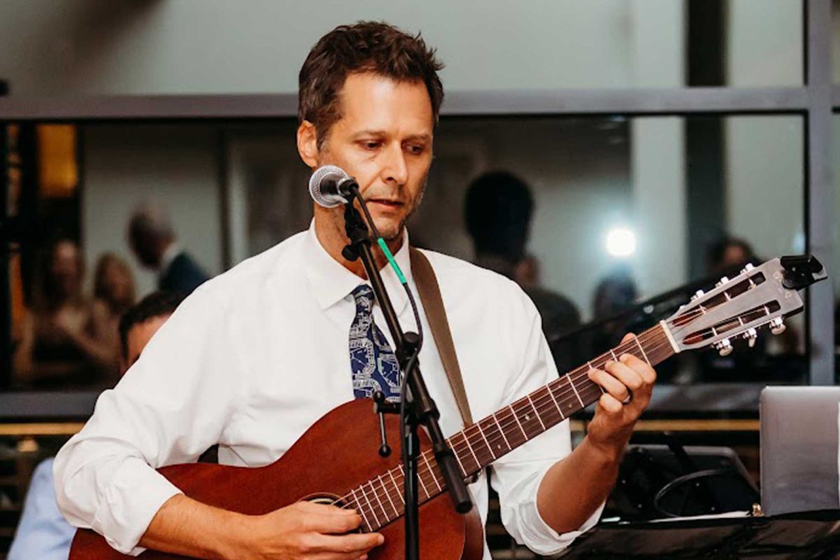 STRUMMING SONGS • English teacher Mr. Robert Zakrzewski strums his guitar at his parent’s 50th anniversary. PHOTO: Marisa McGovern, MnM Family Photography