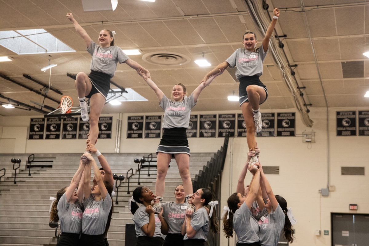 Haven's varsity game day cheerleading team complete a lift successfully, their performance closing off the morning of cheer performances by other high school teams in the area.