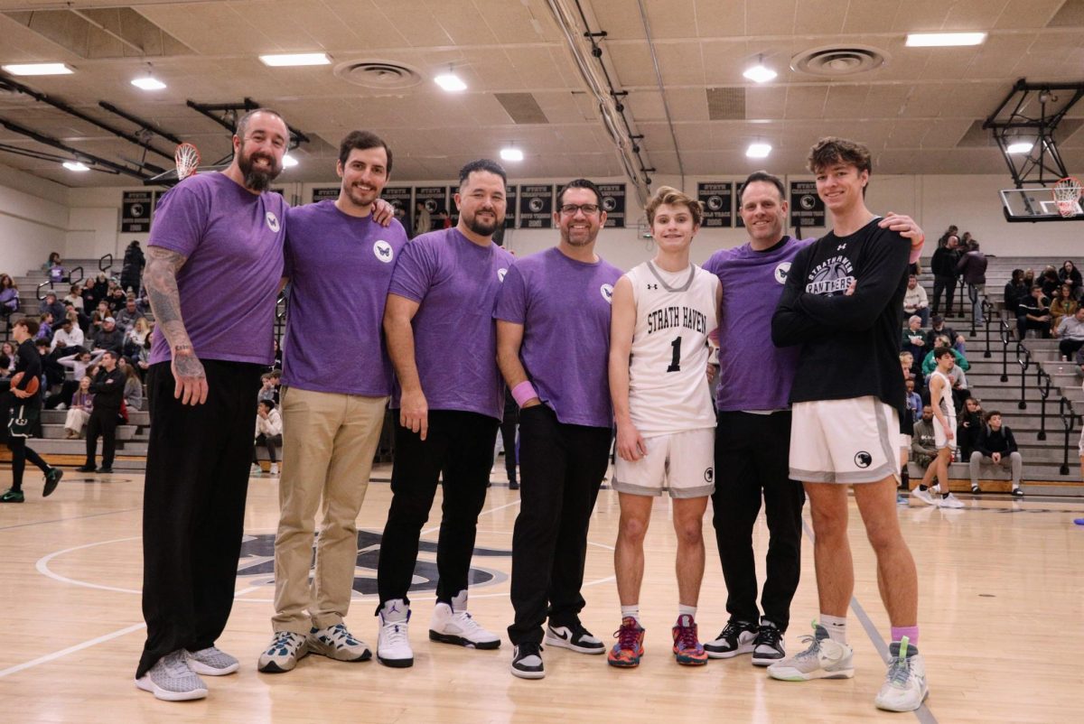 Strath Haven coaches and senior captains Jacob Wenke and Justin Wilson pose for the Hope for Hallie game. To honor Hallie Jackson, coaches of both teams wore purple Hope for Hallie shirts. 