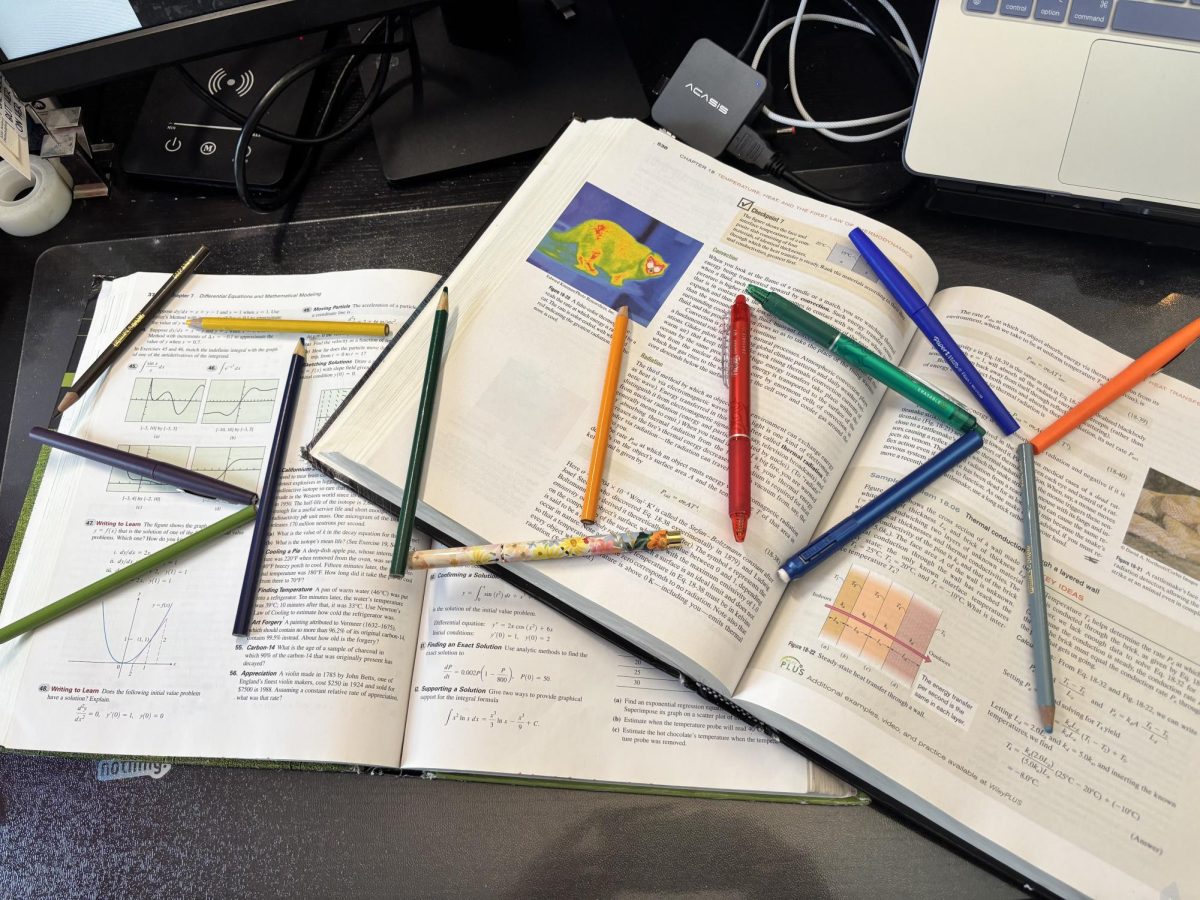 'Study' is spelled out across textbooks with colored pencils and pens.