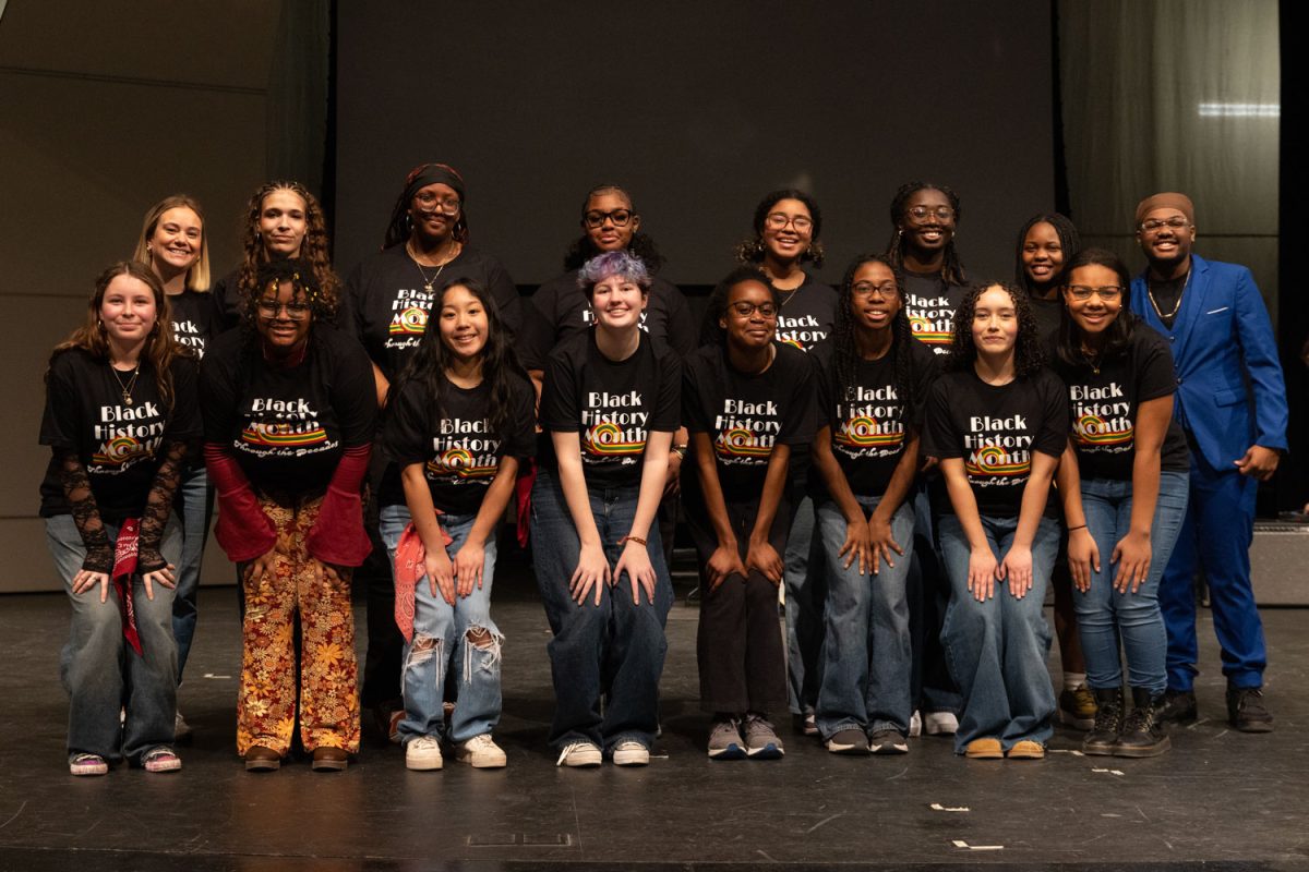 Student performers at the 2025 Black History Month assembly pose for a group photo after the event with teacher on special assignment Ms. Alissa Harvey. 