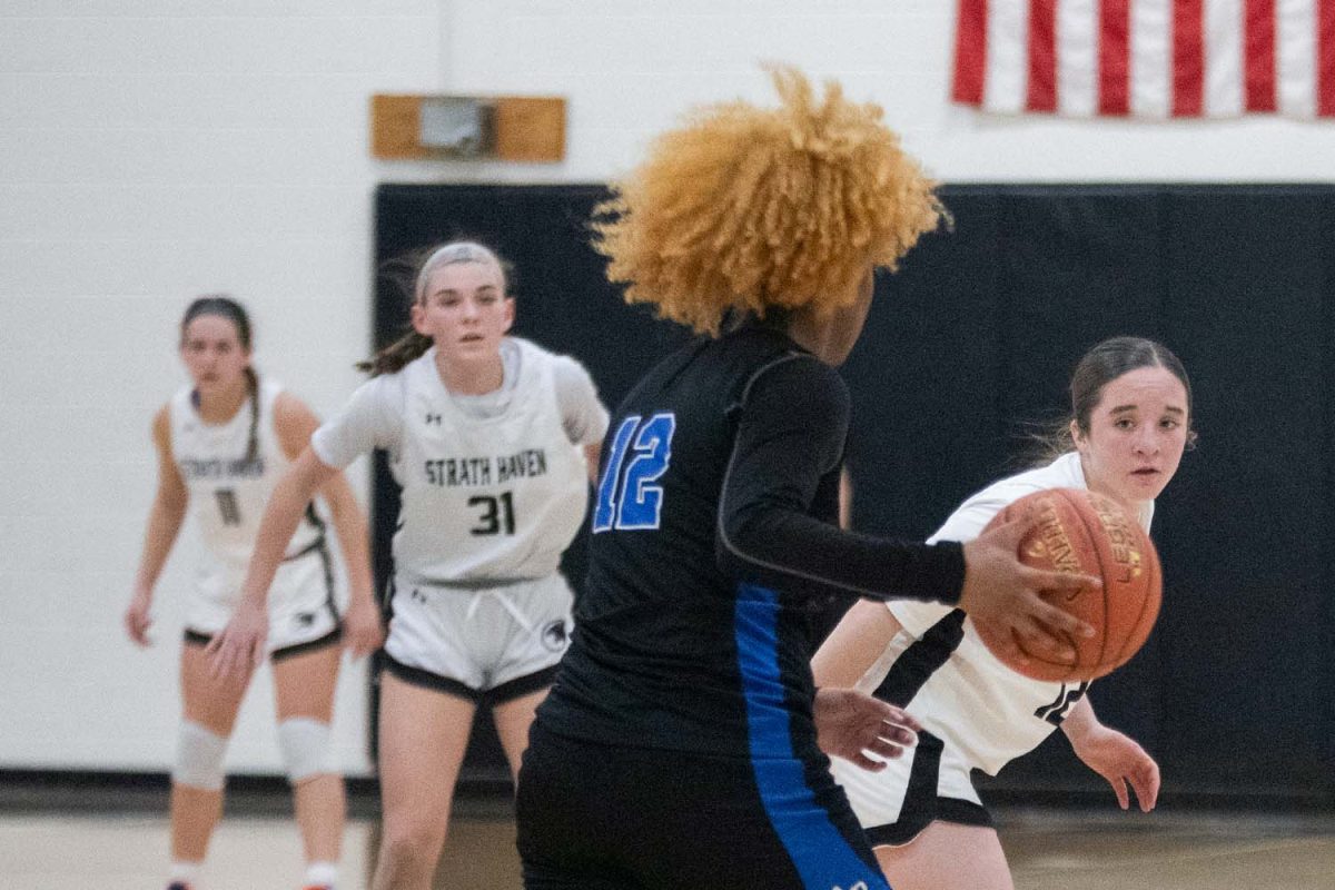 Freshman Maddie Fanning strategizes on how to take possession of the ball during the playoff game on Friday, February 14.