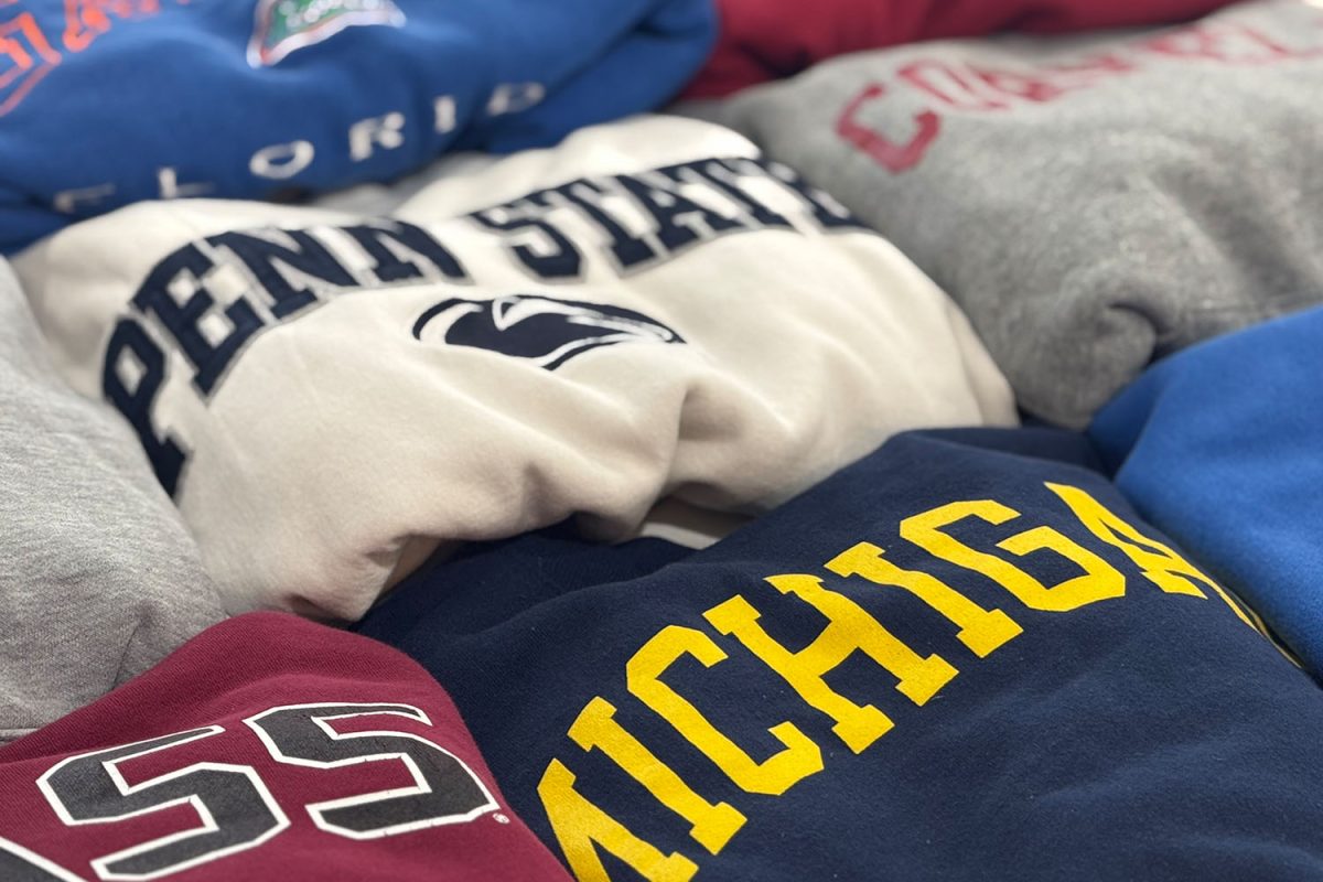 A collection of college apparel sits, arranged together. 