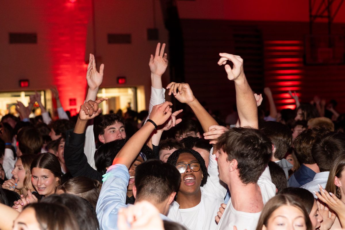 Students raise their hands in the air to the music at Frosh on Thursday, March 13 in the Strath Haven High School gymnasium.