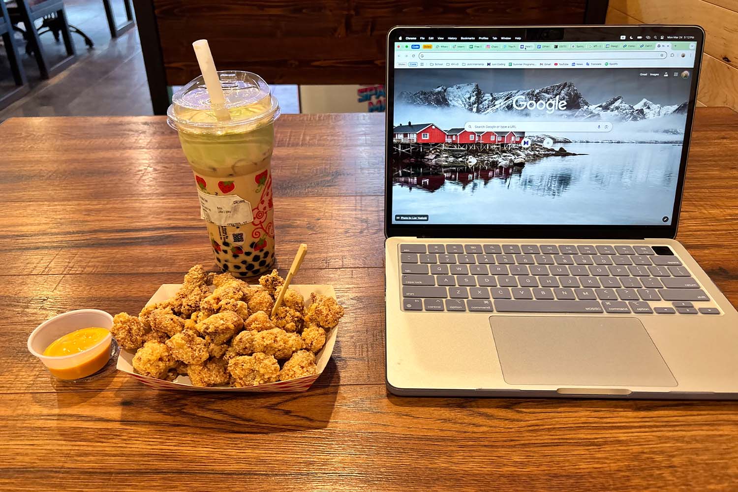 A student prepares to study with a bubble tea and popcorn chicken meal for company. Kung Fu Tea is often used as a study spot as well as a bubble tea store.