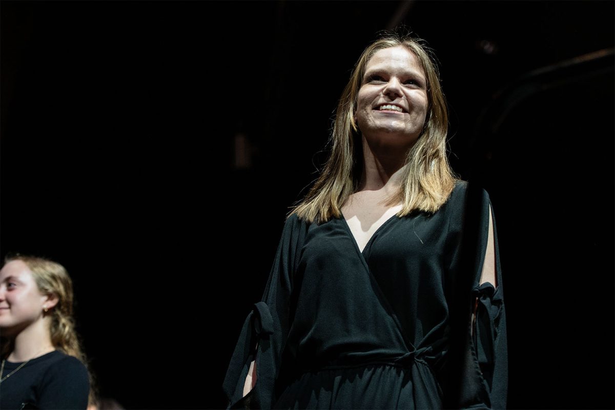 Ms. Samantha MacFarlane smiles at the crowd after conducting at the winter symphonic band and orchestra concert on March 19. 